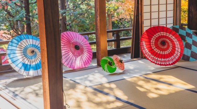 colorful oriental umbrellas on floor in light room