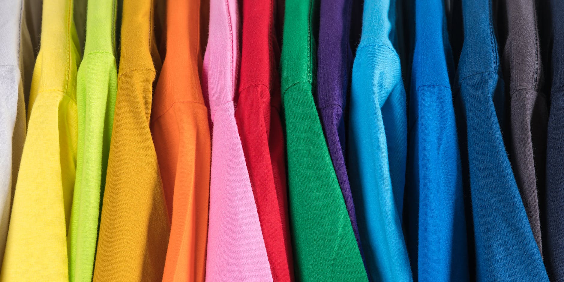 collection of multicolored t shirts in shop